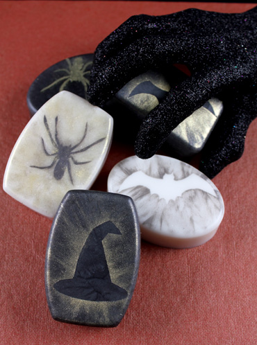 A collection of Halloween soap decorated with stenciled designs in sparkly micas. 