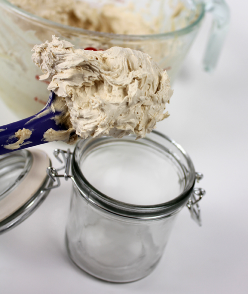 Scooping butter into jars